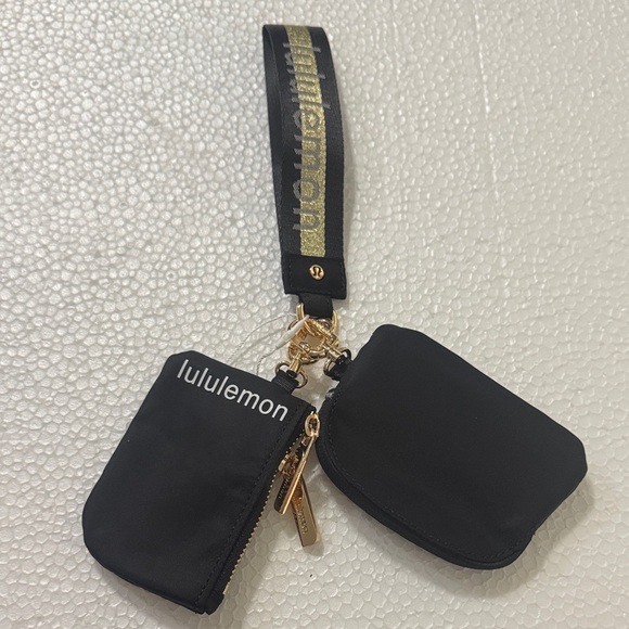 lululemon athletica Handbags - lululemon athletica Black and Gold Wristlet Set